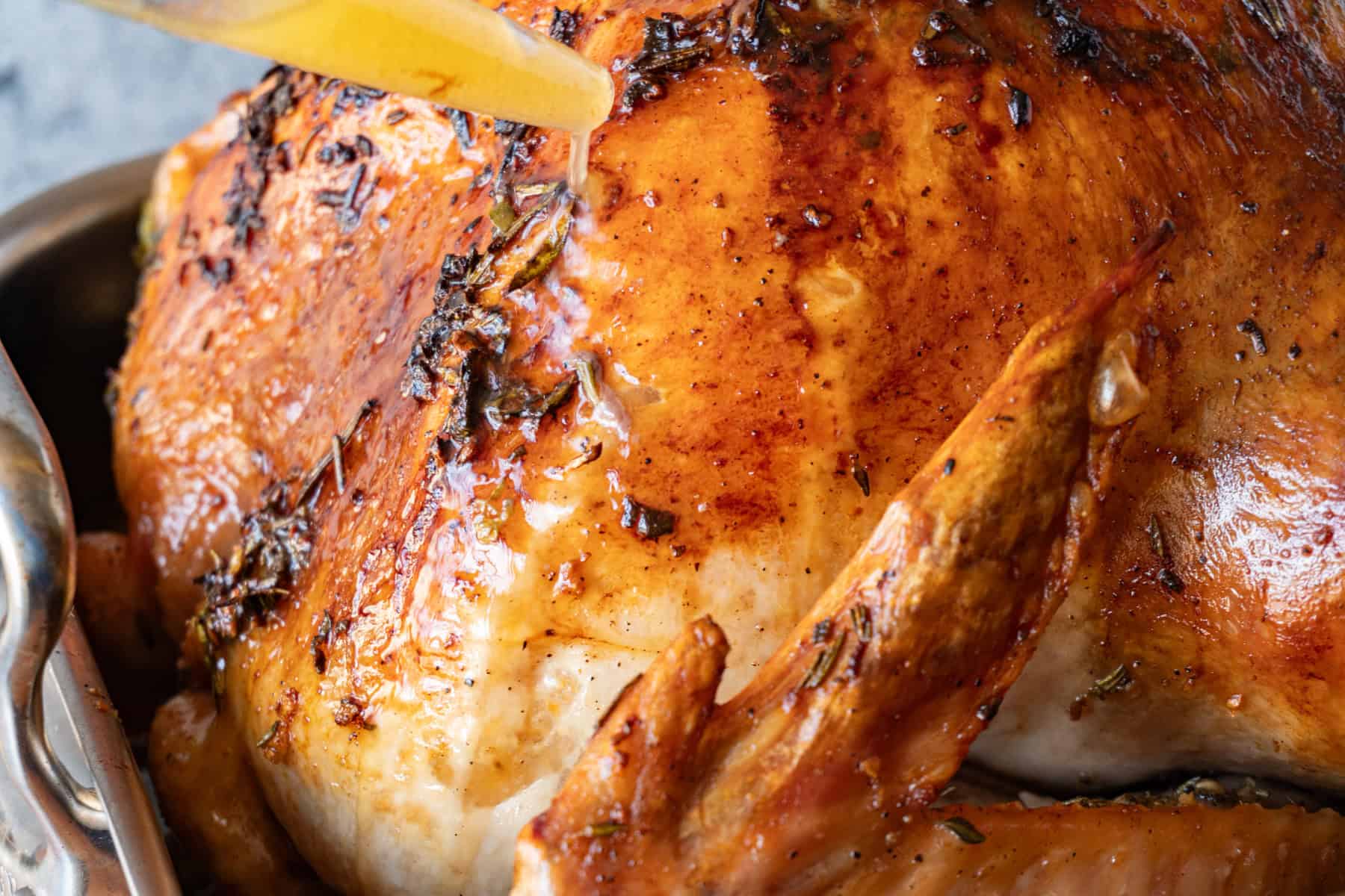 basting herb butter turkey with it's own juices.
