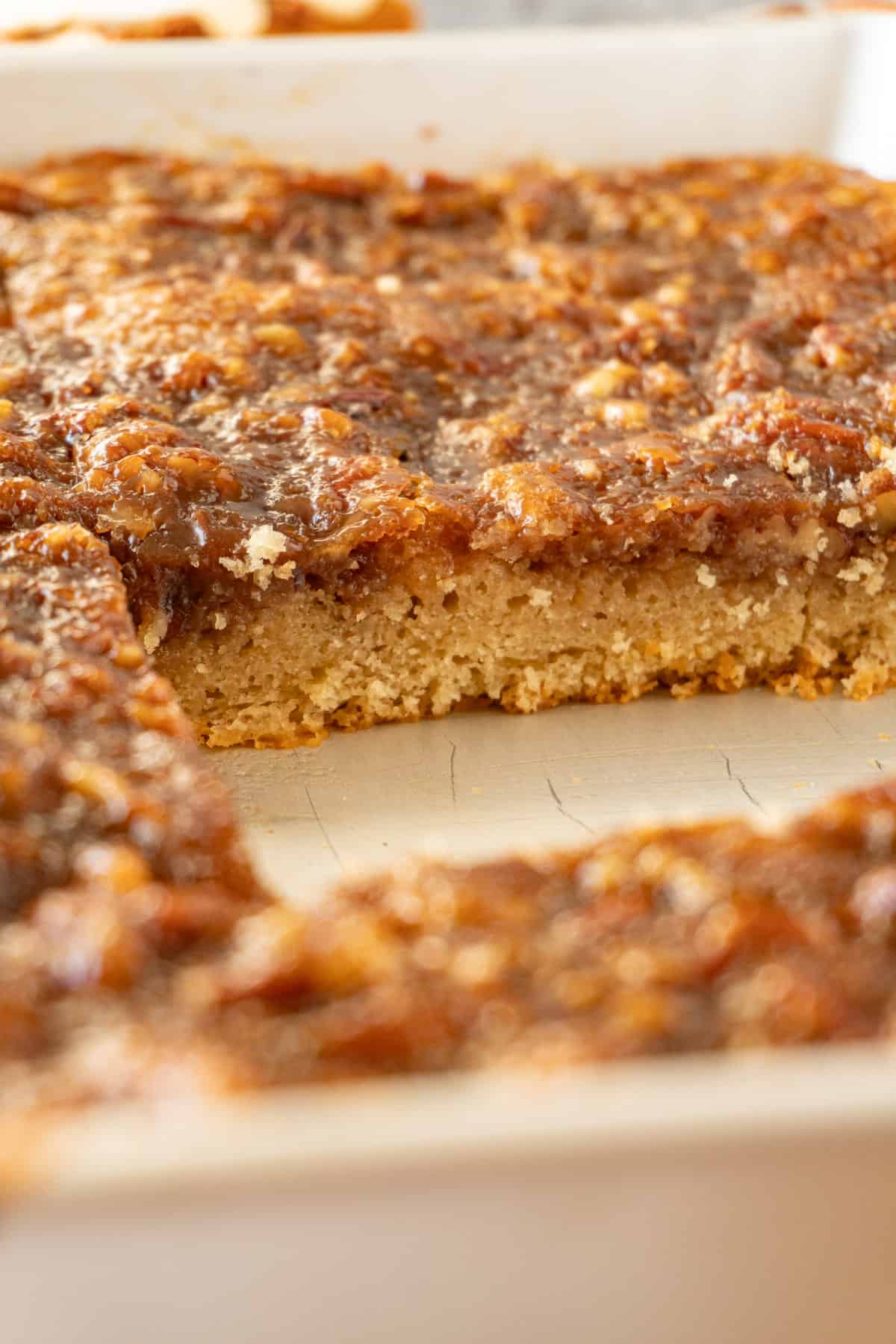 Pecan pie cake in pan with piece missing