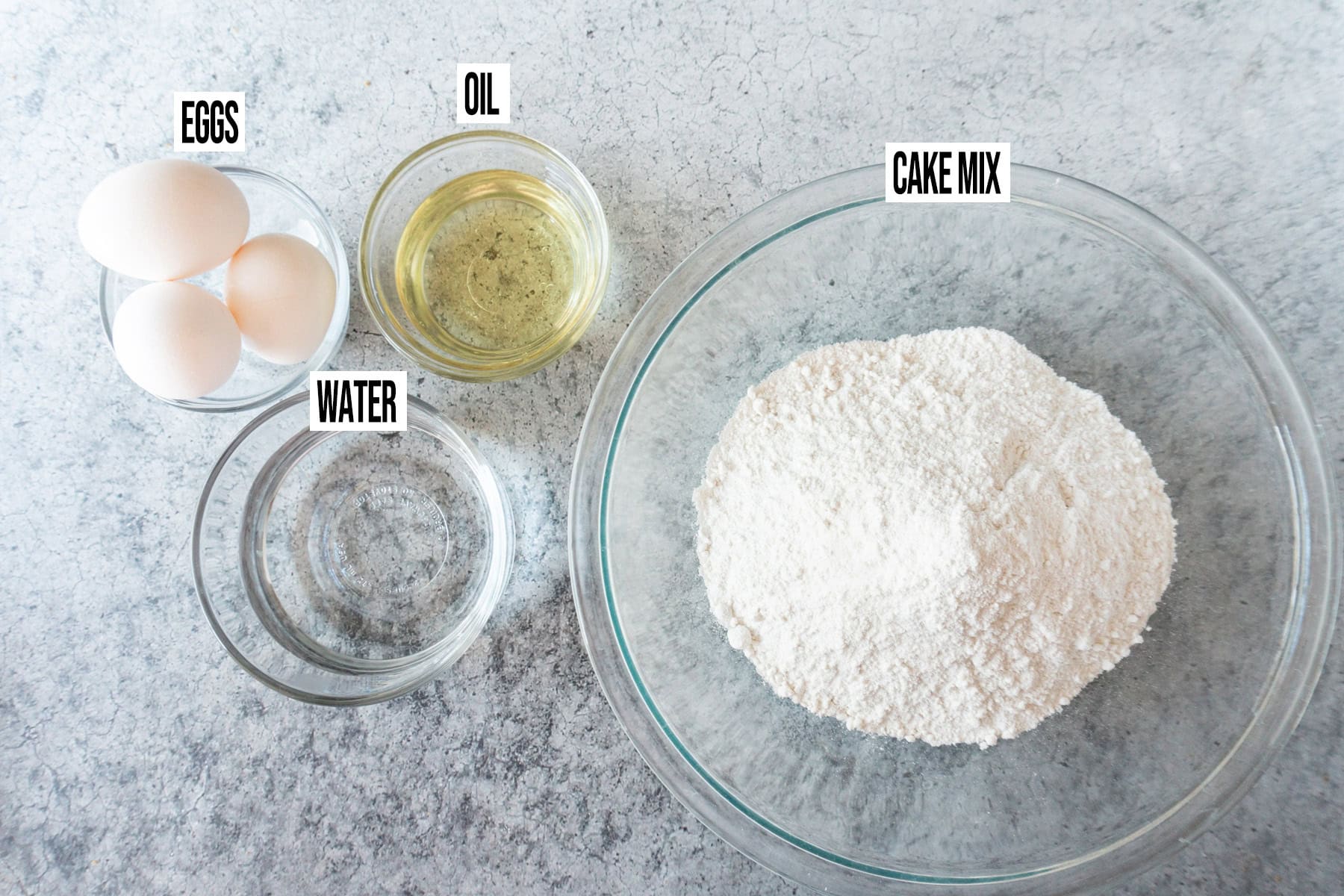 Pecan Pie Cake Ingredients in individual bowls and labeled.