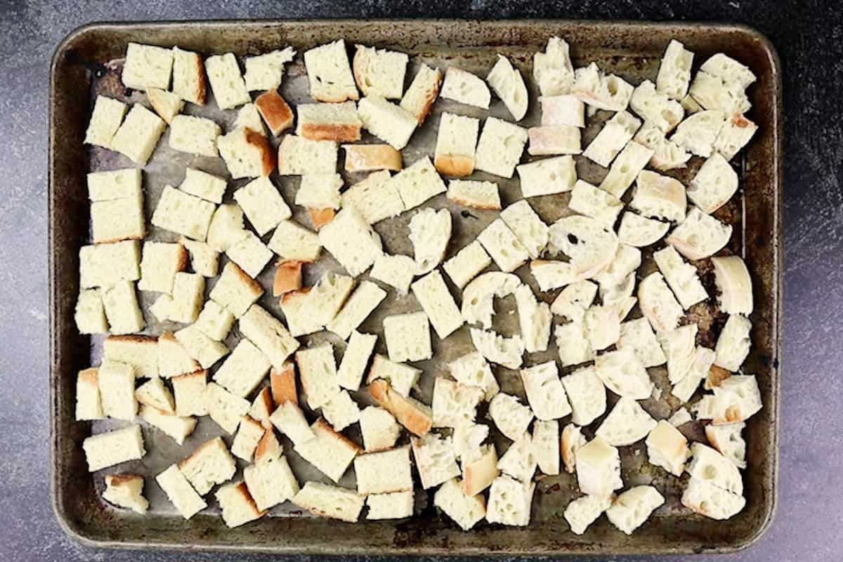 cubed bread on baking sheet