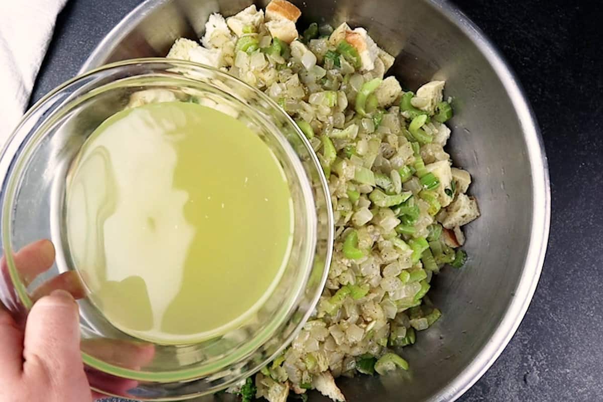 adding broth to bread, herbs, onion, celery