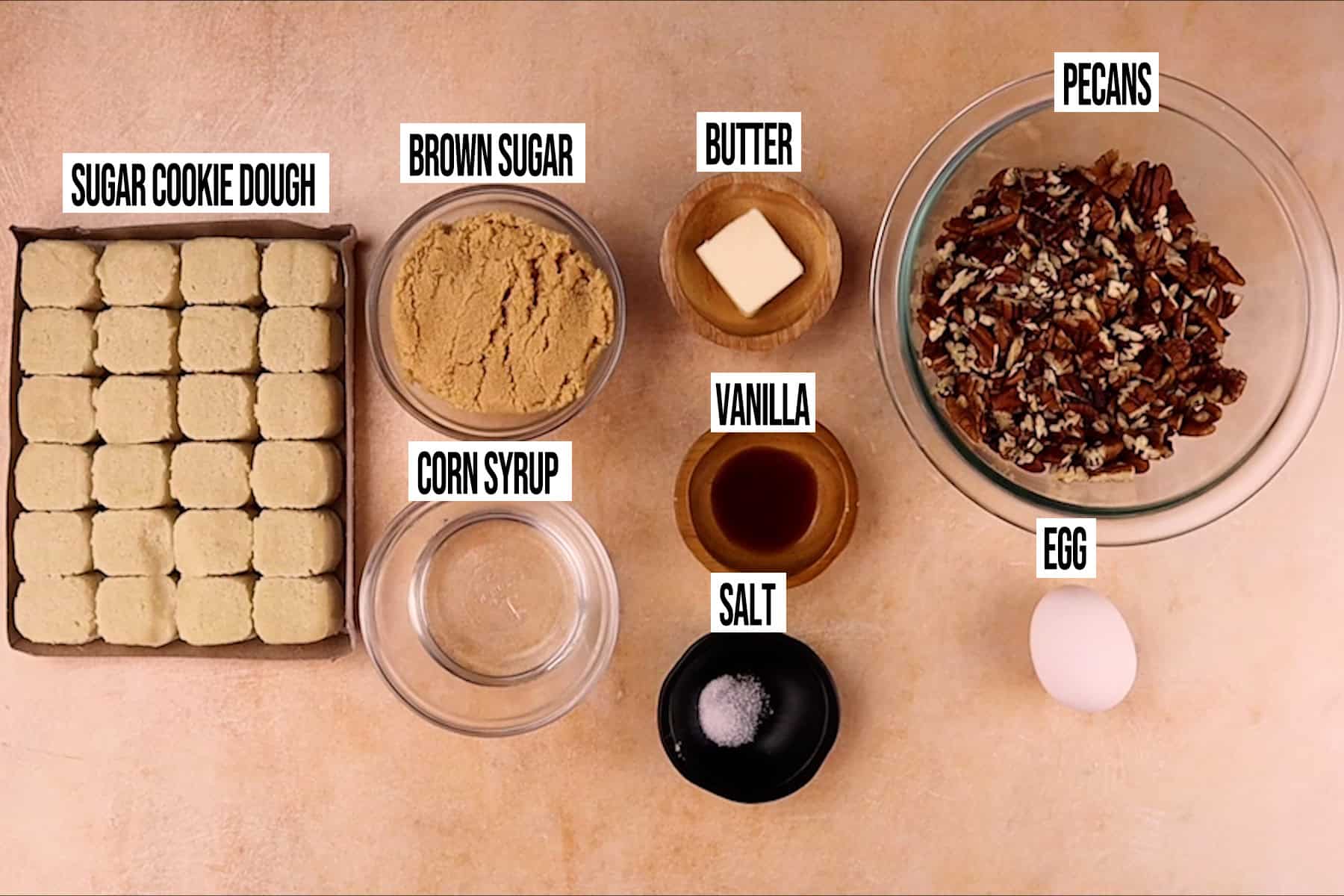 mini pecan pie tart ingredients in individual bowls and labeled.