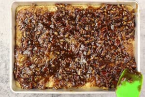 adding pecan pie topping to cake