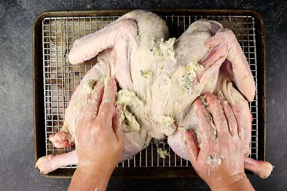 rubbing turkey with herb butter