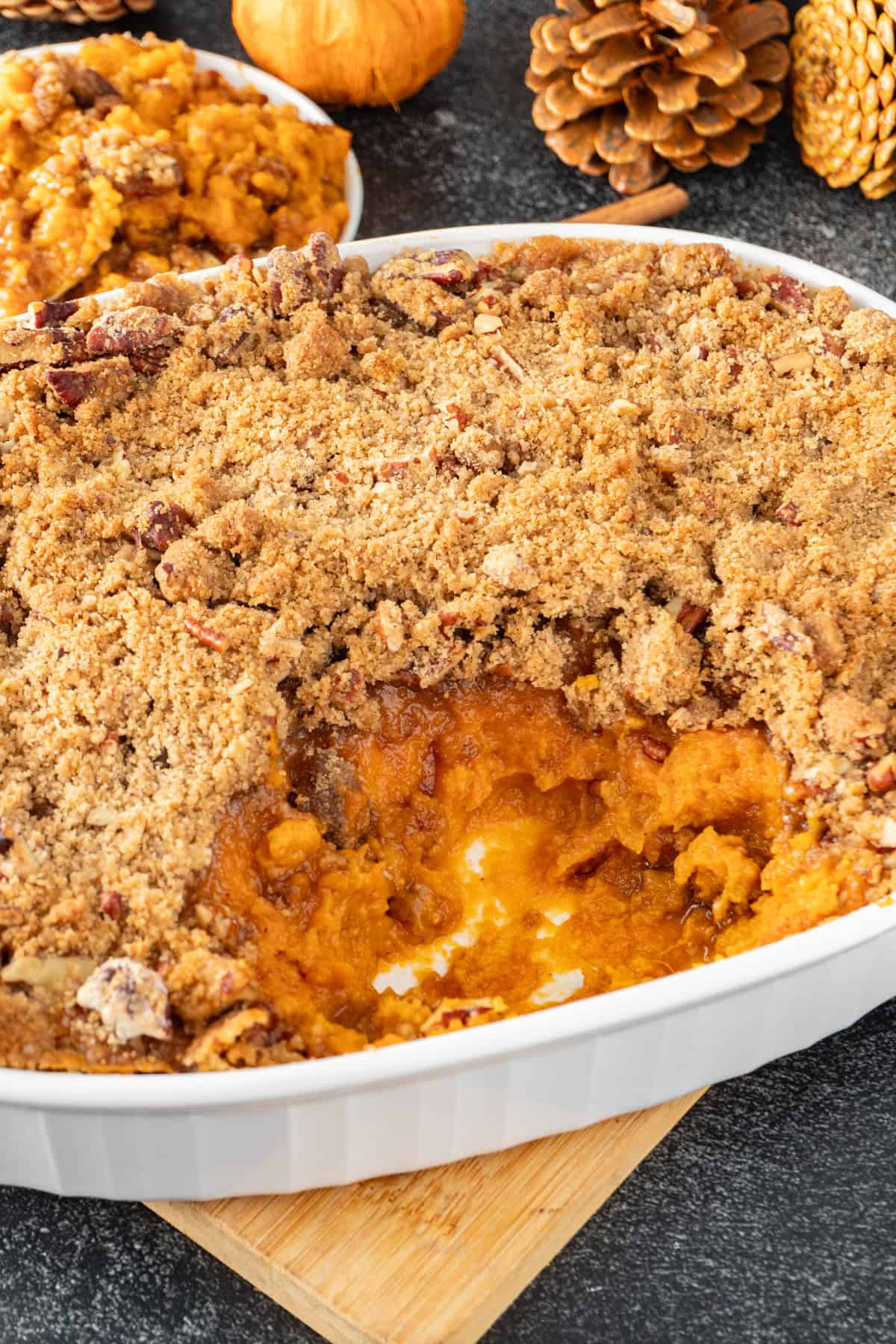 sweet potato souffle in white baking dish with a scoop of souffle taken out.