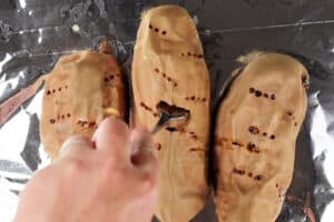 piercing sweet cooked potatoes with fork