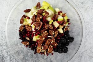 adding fruit for salad to bowl