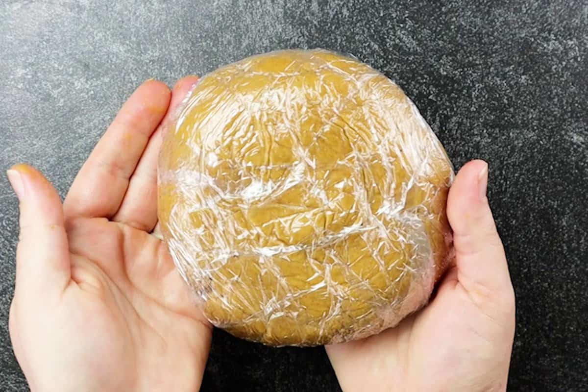 half of dough wrapped in serran wrap