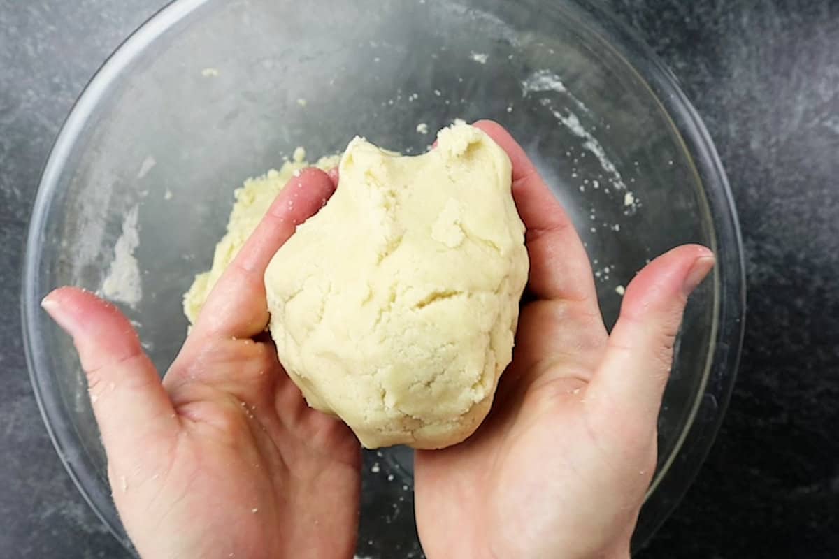 half of cookie dough in hand