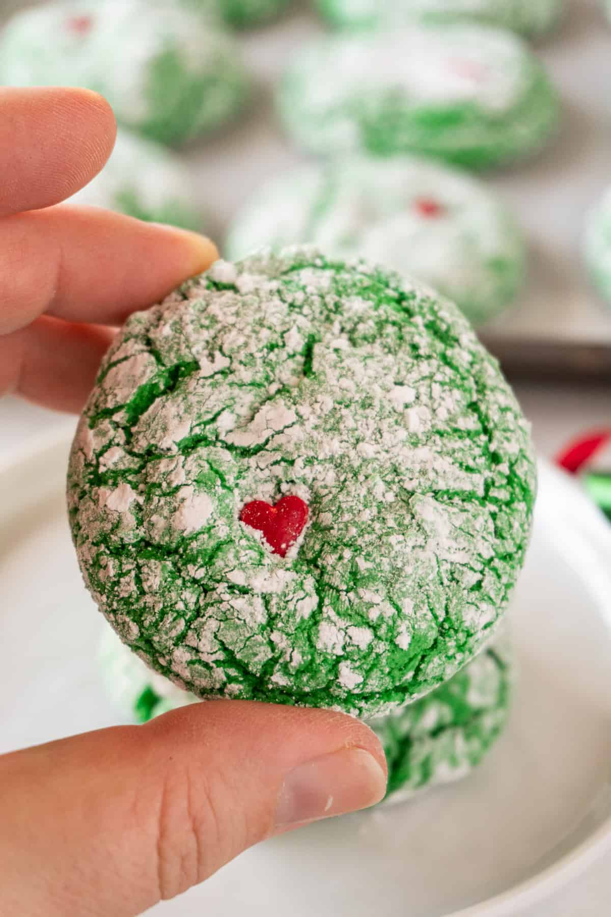 holding a Grinch Cookie in hand