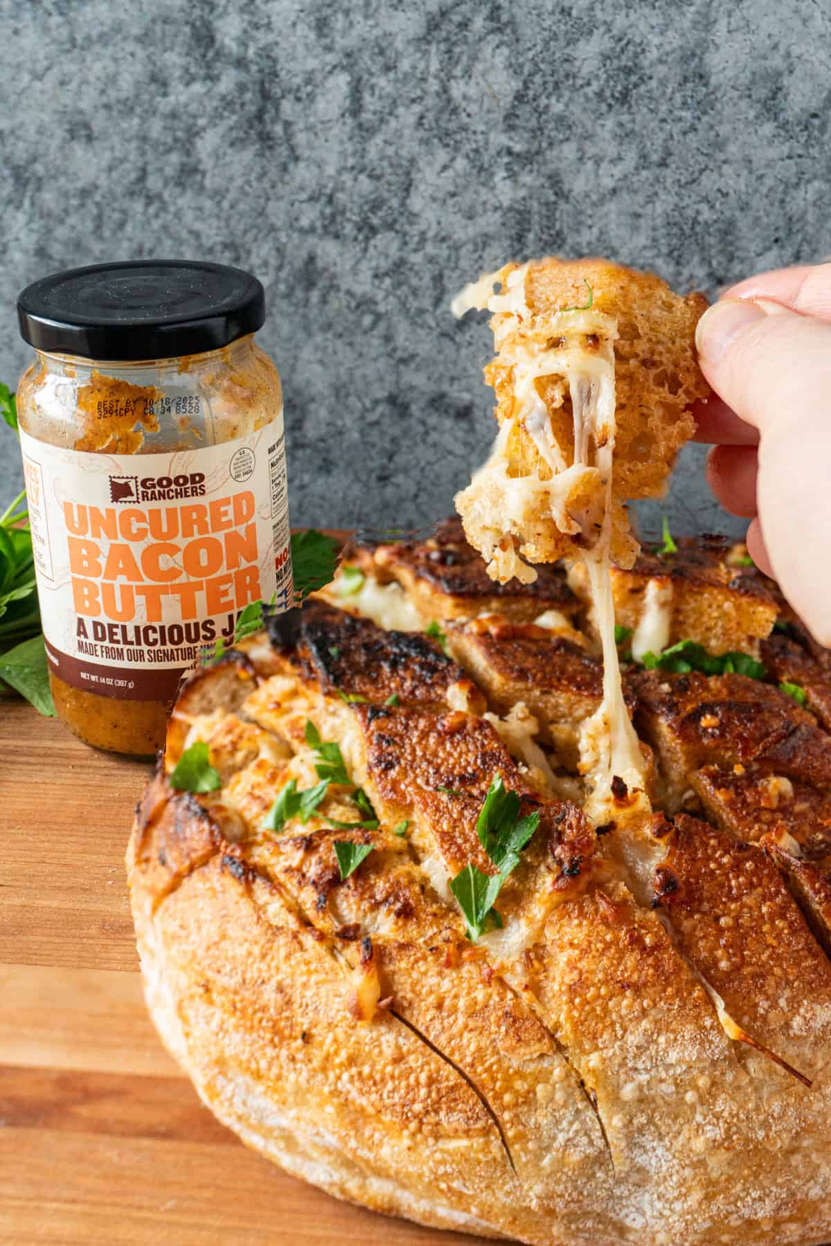 cheesy pull apart bread with bacon jam jar in background