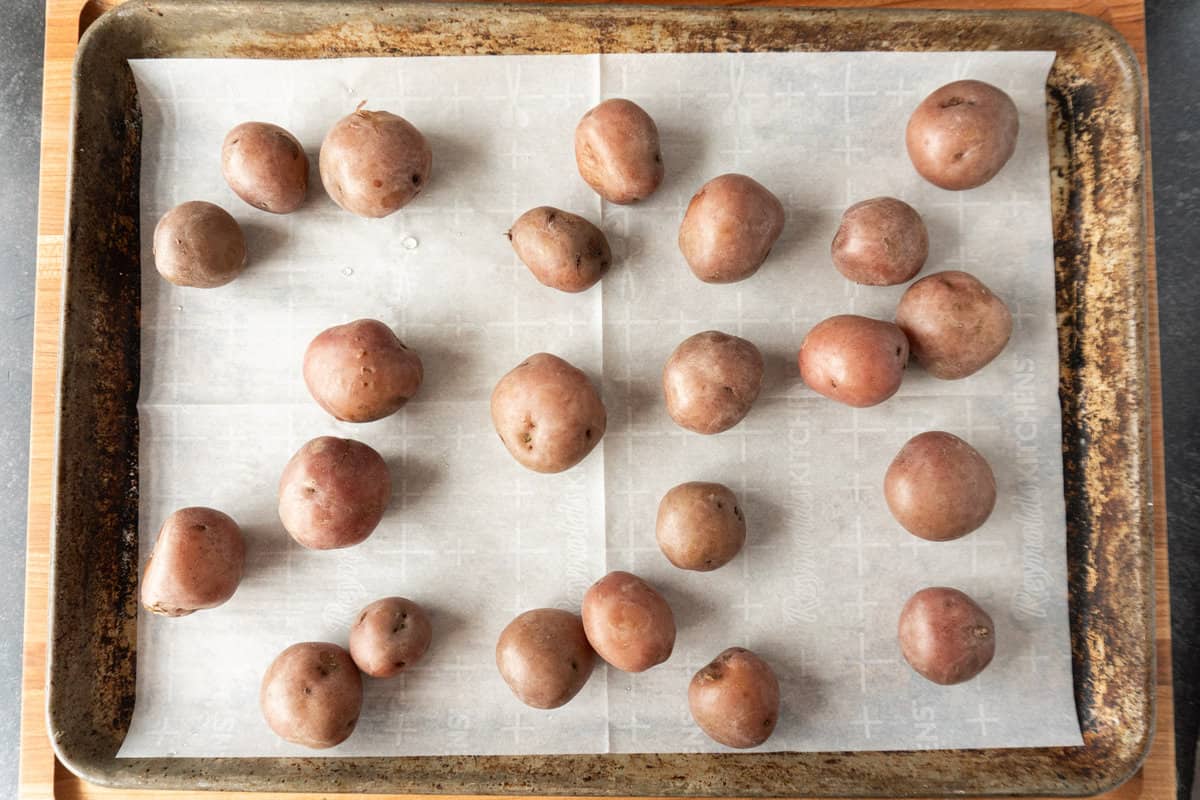 boiled potatoes on baking sheet