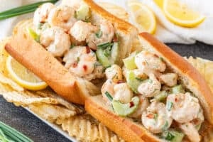 Shrimp Salad Sandwich with chips and lemon wedges