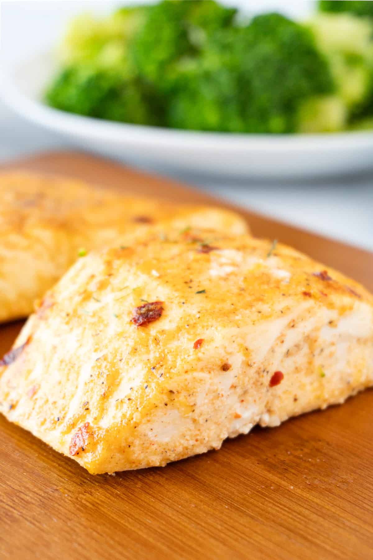 Dijon Baked Halibut on board with broccoli in background