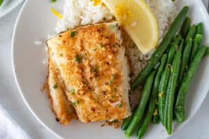 Pan Fried Cod on plate with green beans and rice