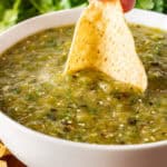 Dipping a chip in Roasted Tomatillo Salsa
