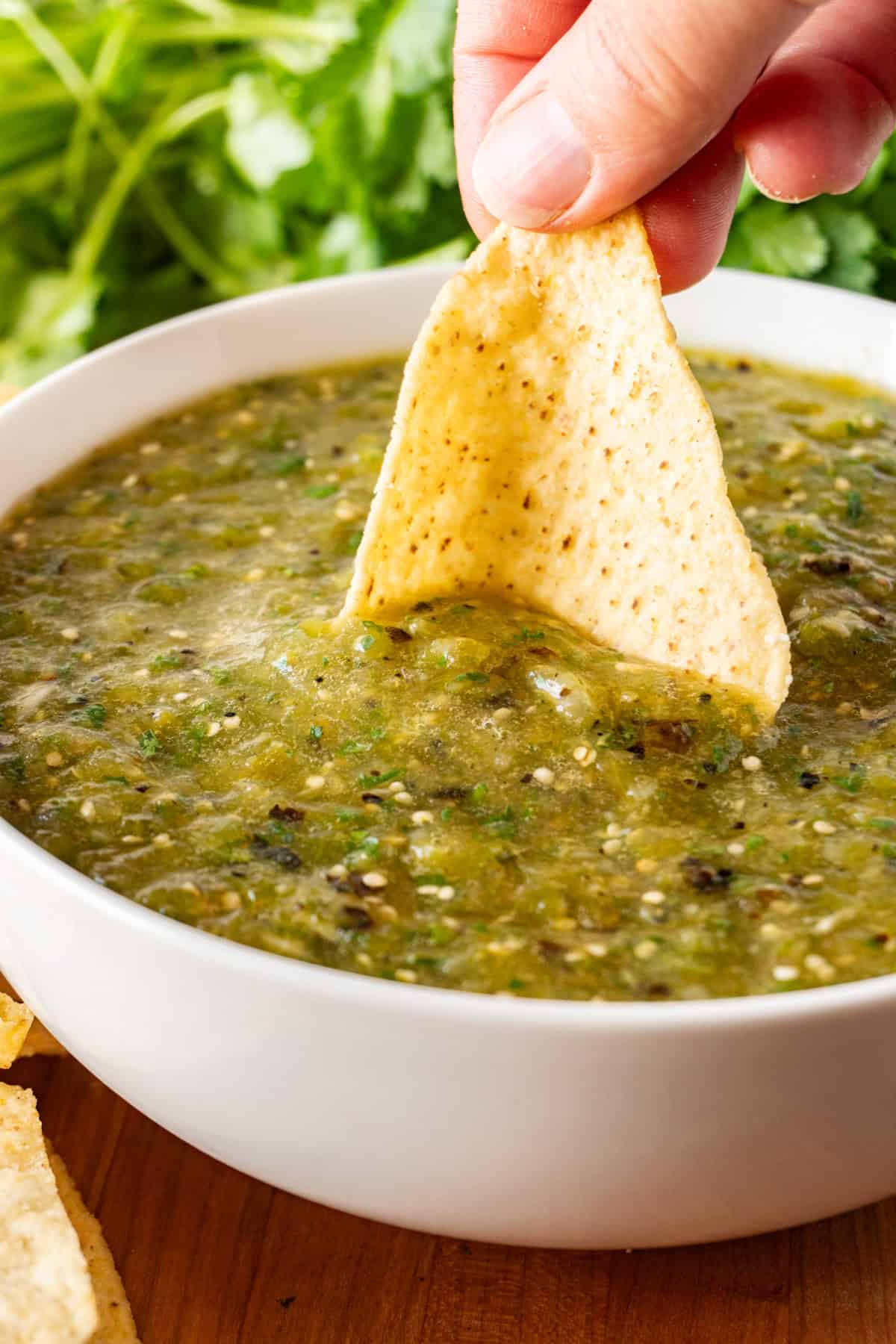 Dipping a chip in Roasted Tomatillo Salsa