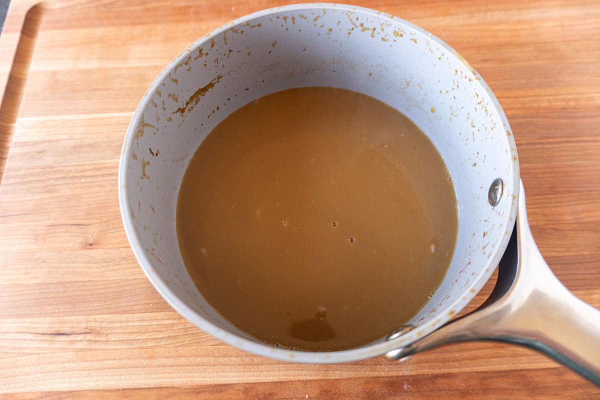 cranberry molasses glaze with butter added in sauce pan.