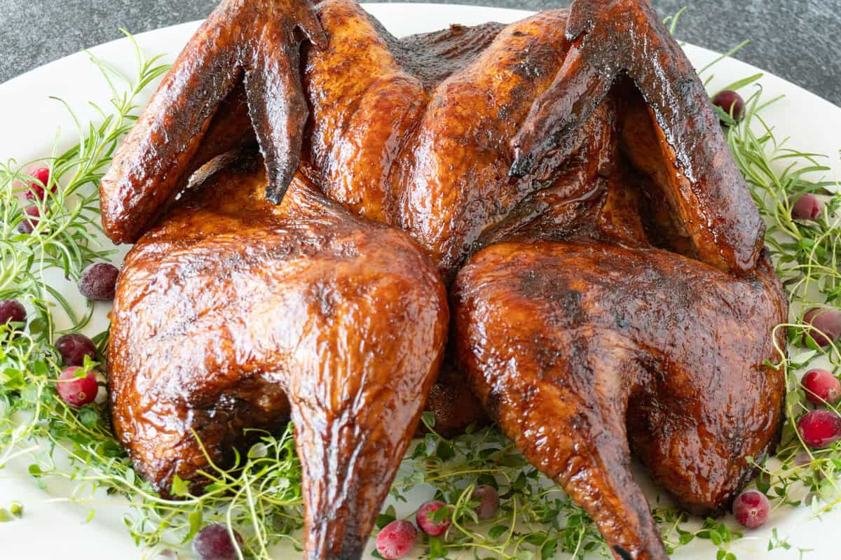 smoked spatchcock turkey on platter,