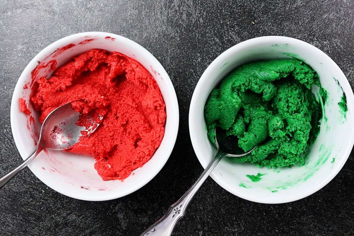 red and green colored oreo filling in bowls