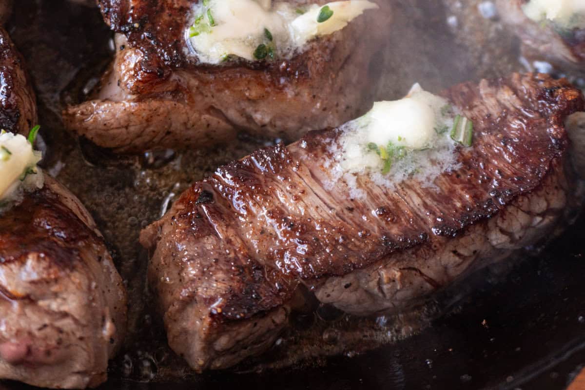 close up of filet medallions in cast iron skillet.