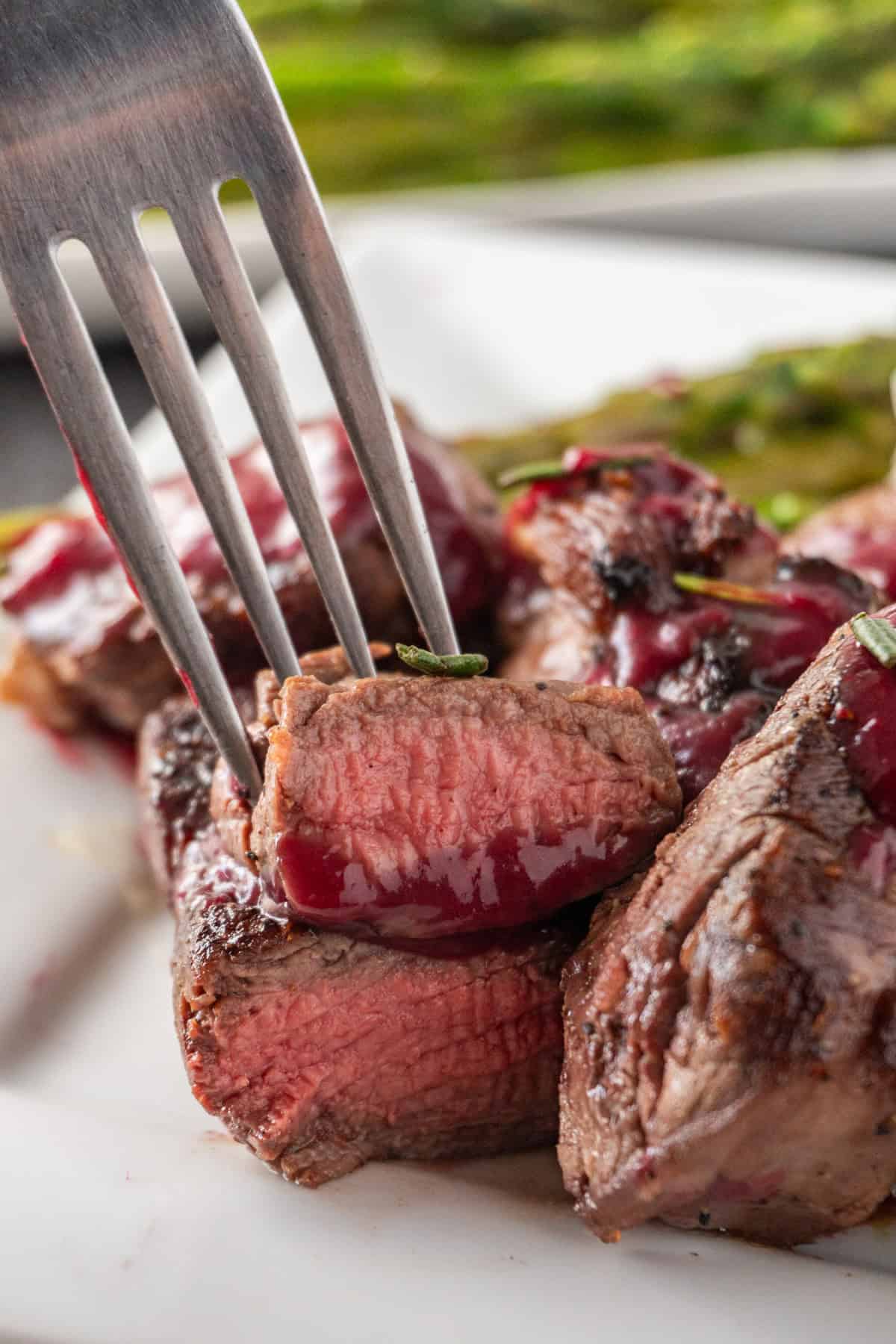 piercing a piece of meat with fork.