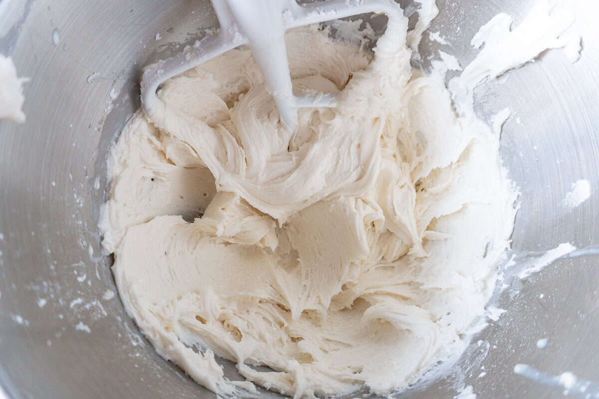 white frosting in bowl stainless steel bowl.