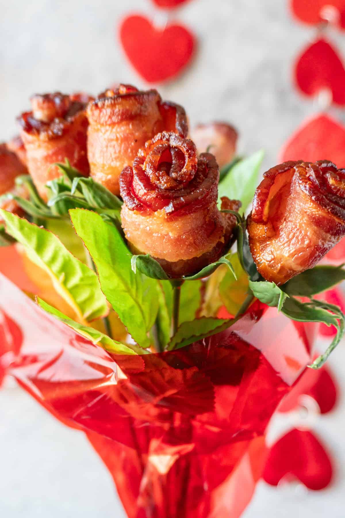bouquet of bacon roses wrapped in red cellophane.