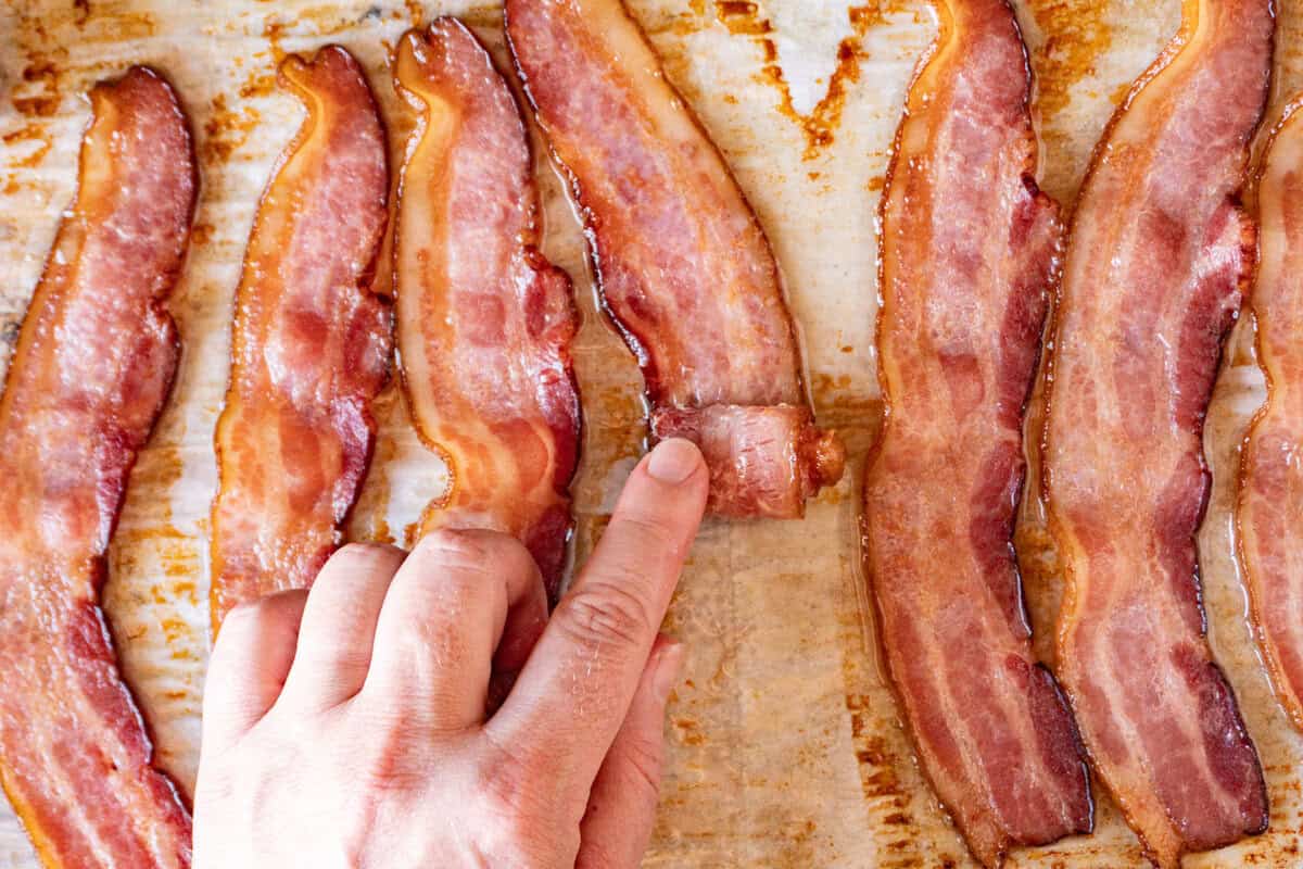 rolling a slice of bacon into a rosette.