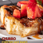 churro cheesecake bar topped with caramel sauce and chocolate sauce and strawberries pinterest pin