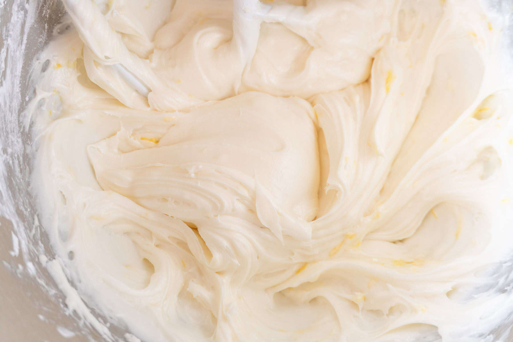 orange cream cheese frosting in mixing bowl.