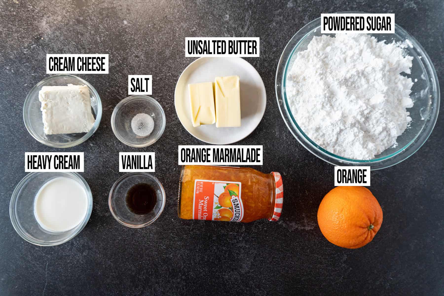 ngredients for orange cream cheese frosting in individual bowls and labeled..