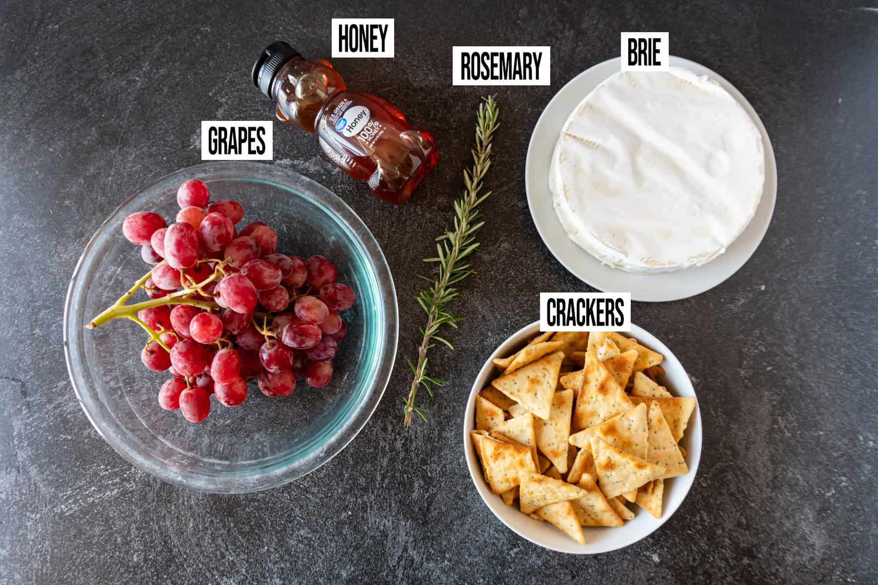 baked brie ingredients laid out and in individual bowls and labeled.