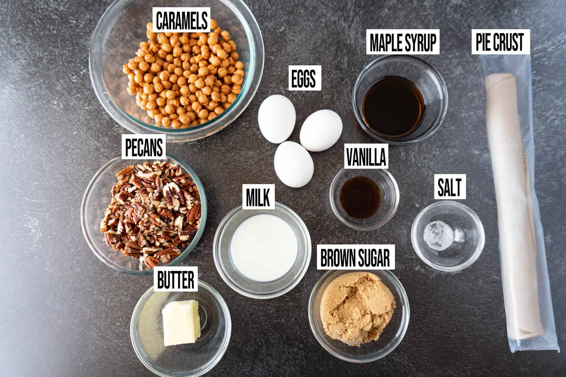Caramel Pecan Pie ingredients laid out and in individual bowls and labeled.
