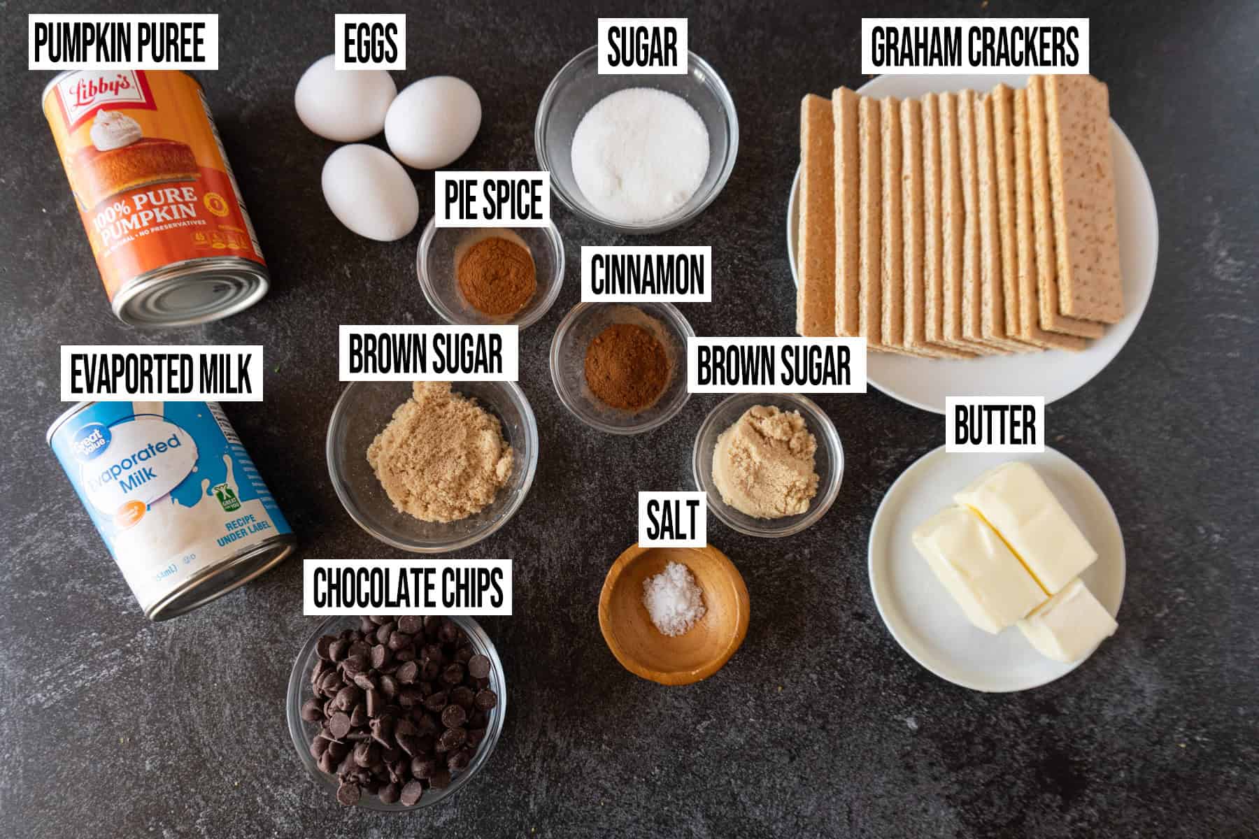 Chocolate pumpkin pie ingredients laid out and in individual bowls and labeled.