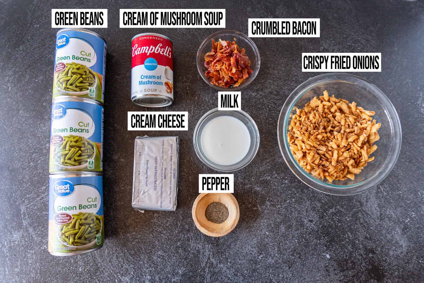Green Bean casserole with cream cheese ingredients laid out and in individual bowls and labeled.