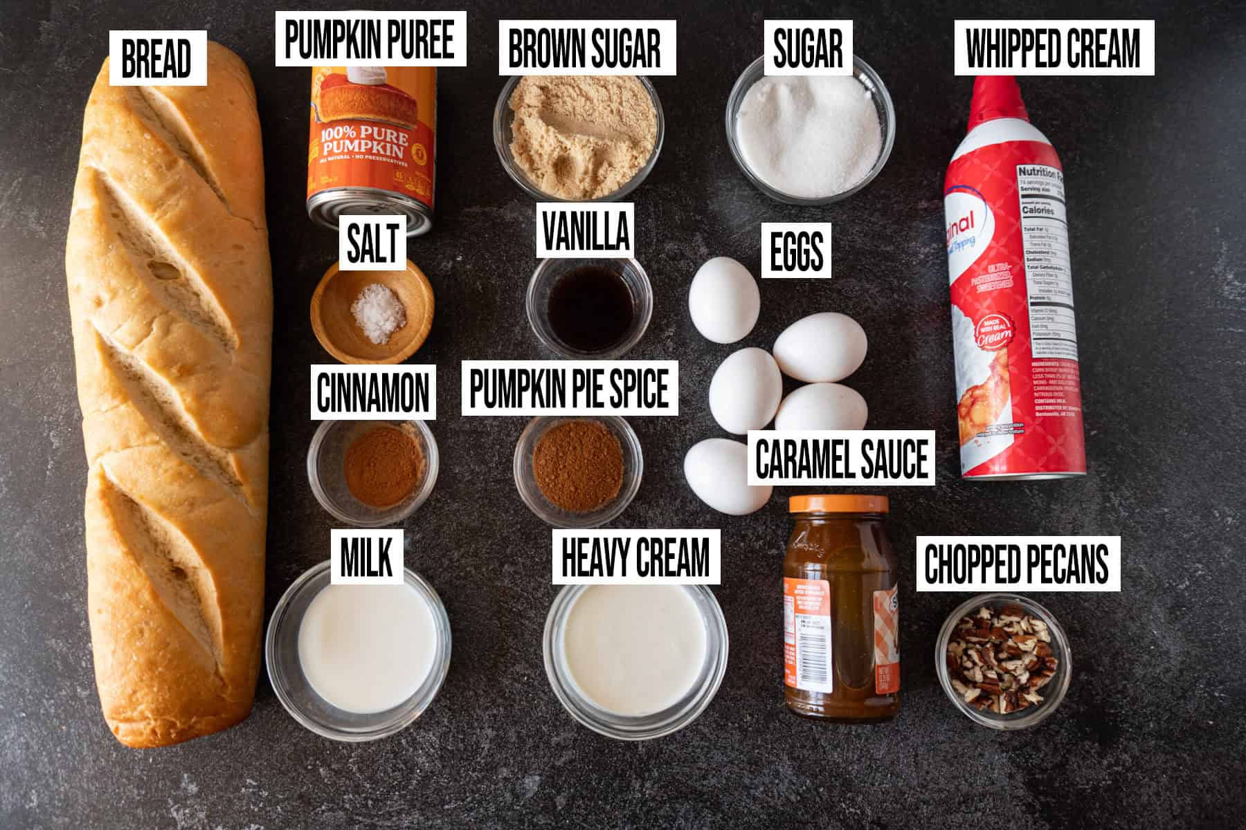 Pumpkin Bread Pudding ingredients laid out and in individual bowls and labeled.