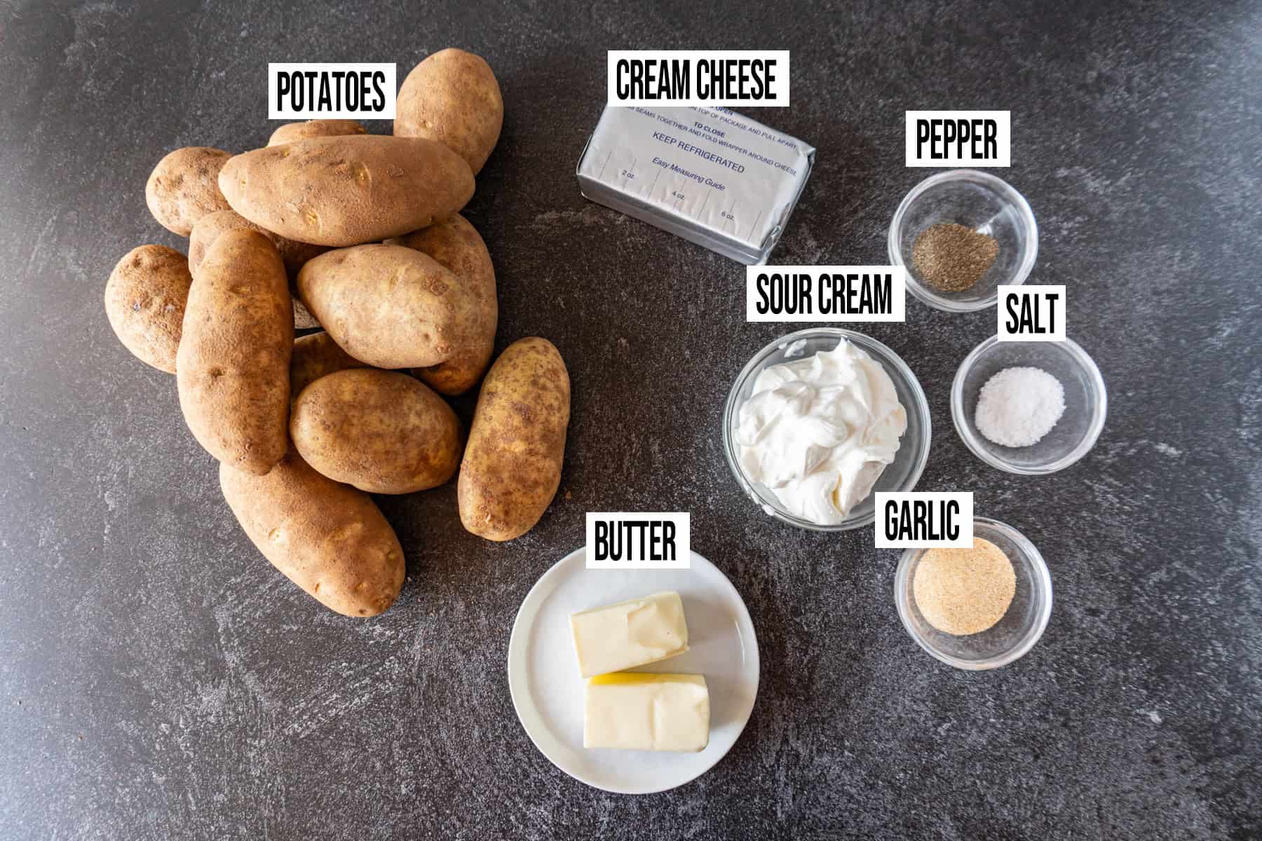 Sour Cream Mashed Potatoes ingredients laid out and in individual bowls and labeled.